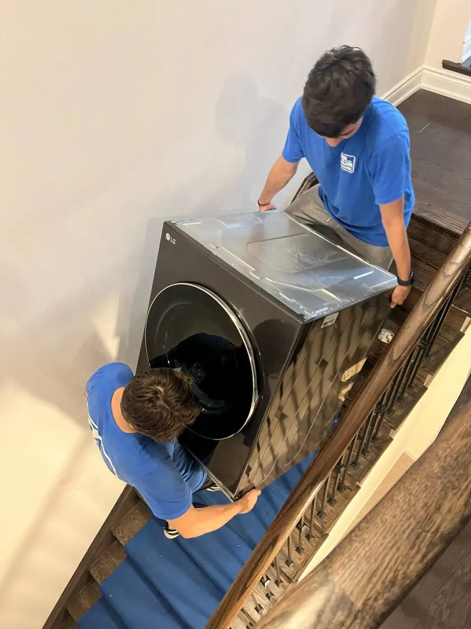 young-delivery-man-using-touchpad-while-reading-label-package 1